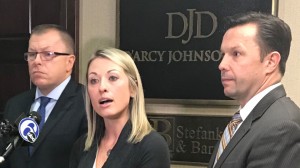 Kimberly Pack surrounded by her attorneys, Patrick and Andrew D'Arcy